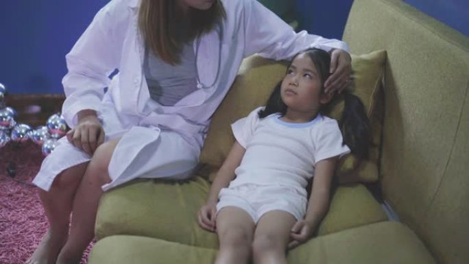 亚洲医生检查生病的女孩，孩子有发热