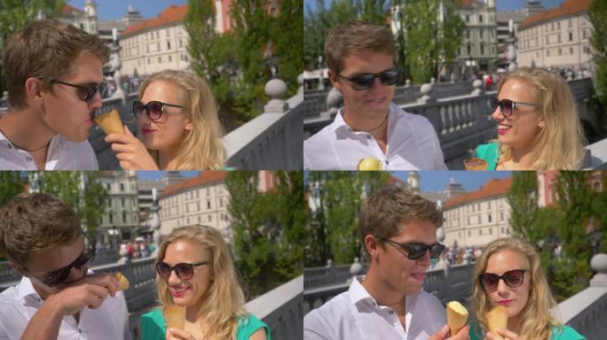 慢动作: 顽皮的女孩将男友的鼻子浸入冰淇淋蛋筒中。