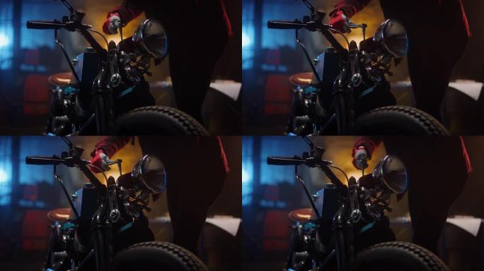 在车库或创意车间中，特写一名戴着红色工作手套的机械自行车爱好者的镜头。有才华的人在用棘轮定制自行车上