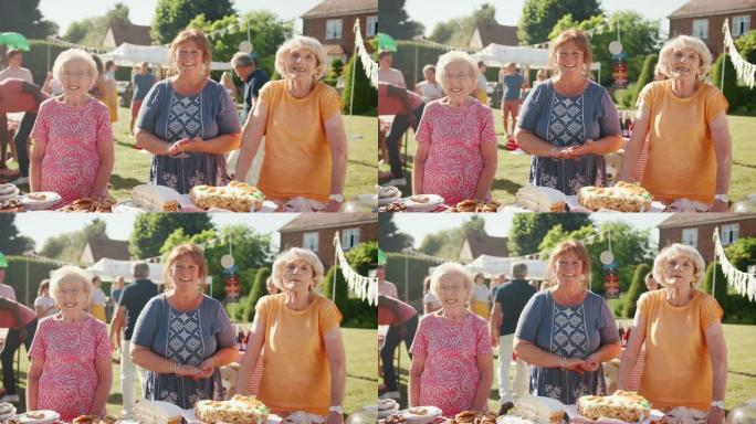 英国夏季花园宴会上在蛋糕摊上服务的三个成熟女性的肖像-慢动作拍摄
