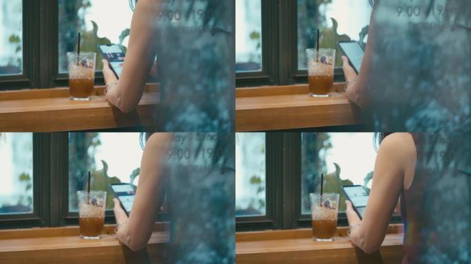 在咖啡店使用智能手机的女人