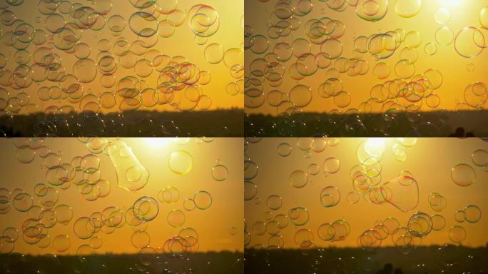 肥皂泡在金色的夕阳光芒中飞舞。4K