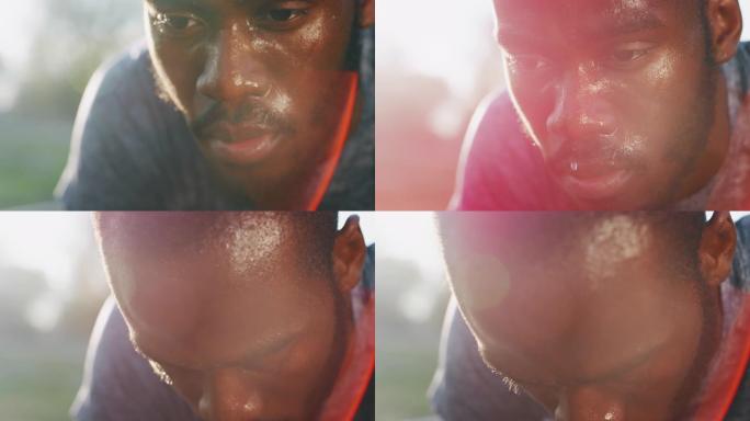 年轻的非洲男运动员的慢动作特写镜头在田径体育场的比赛中从起跑线开始