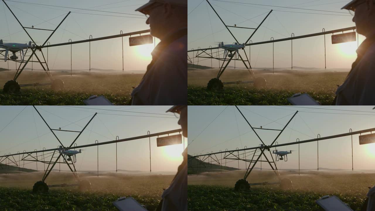 4k背光视图，一个现代农民用无人机在一个大型蔬菜农场使用先进技术监控他的蔬菜作物，背景是中心枢轴