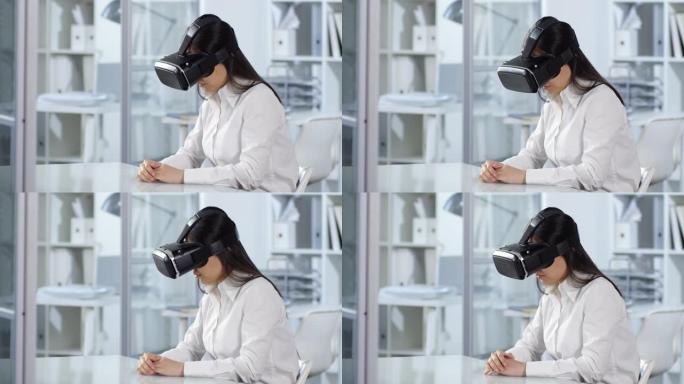 亚洲女性在办公室使用交互式触摸屏和VR耳机