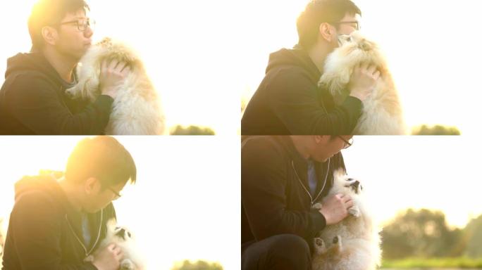 SLO MO-Asian抱着并亲吻他的狗