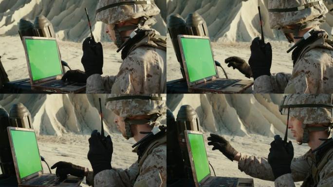 沙漠中的军事行动: 士兵在绿色乔马钥匙屏幕笔记本电脑上工作，使用无线电通信。