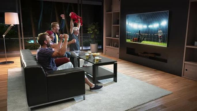 一群球迷正在电视上观看足球时刻并庆祝点球。