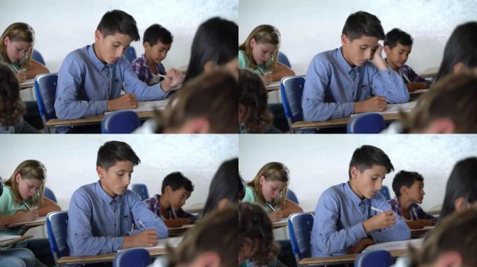 拉丁美洲的年轻男学生在上课时非常专注于笔记本