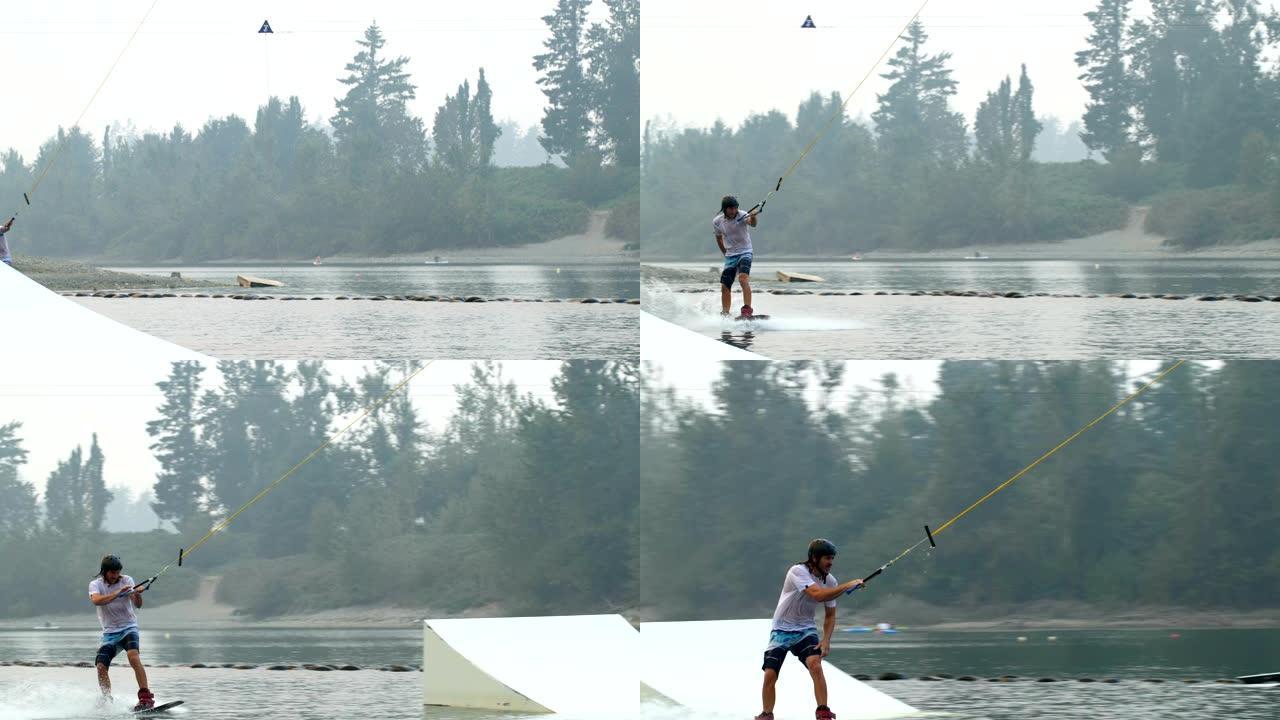 高加索年轻人在4k湖的滑水板上做戏的前视图