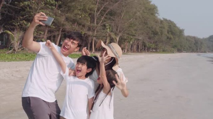 UHD 4k分辨率快乐亚洲家庭在海滩度假时自拍，度假和旅行概念，亚洲家庭生活方式概念。慢动作场景