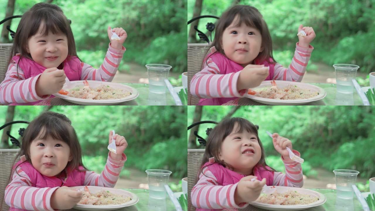 可爱的亚洲小女孩吃午餐