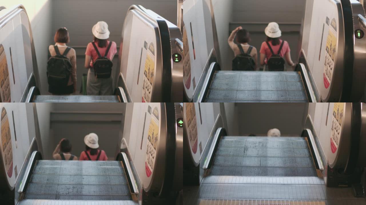 两名女游客在自动扶梯上带着购物袋行走，慢动作