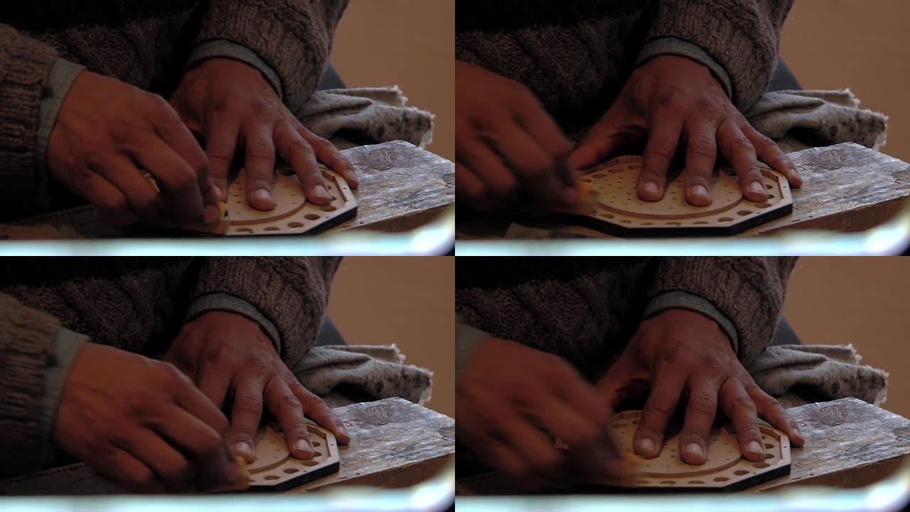 男性手在玻利维亚拉巴斯制作玻利维亚六角琴。特写。