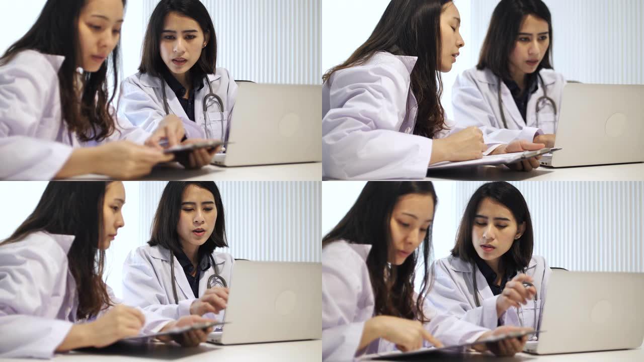 两名医生一起检查数字平板电脑