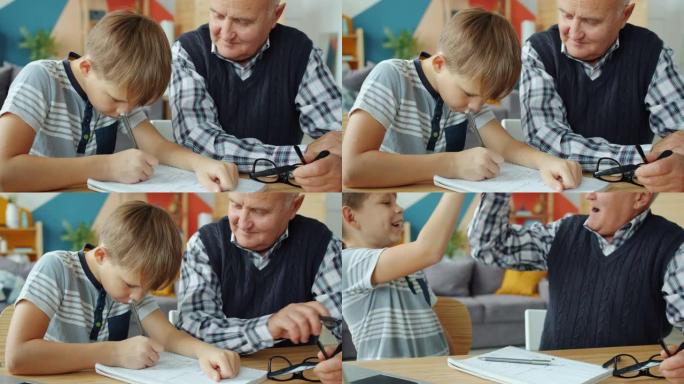 孙子和祖父在家做作业，然后做击掌表示竖起大拇指