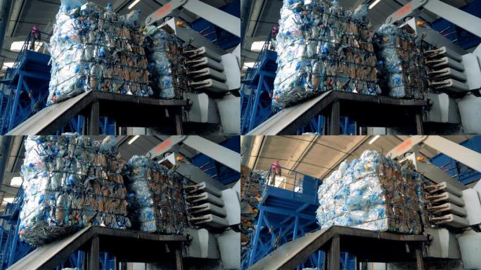 垃圾压榨的过程，特写。大机器准备塑料瓶在工厂回收。