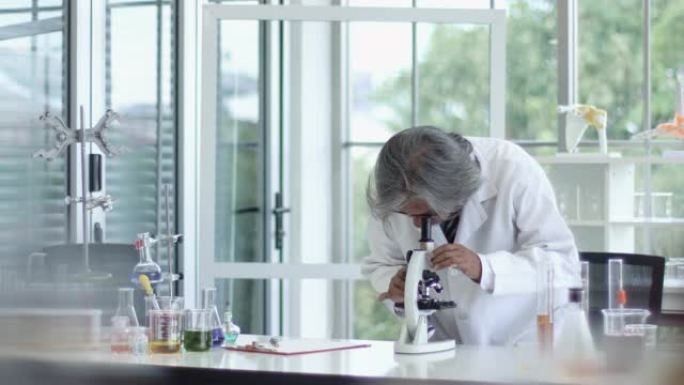 4k: 亚洲科学家在实验室使用显微镜。