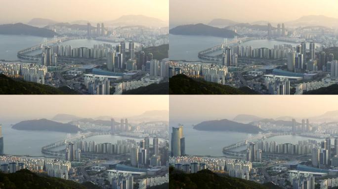 韩国釜山。釜山市中心的广安大桥和摩天大楼的Pannnig拍摄。4K, UHD