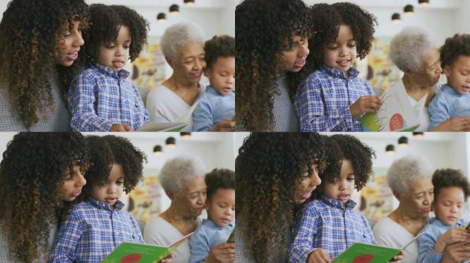 美丽的少数民族年轻母亲正在和她的黑人儿子一起读书