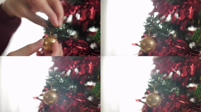 女人用球形装饰品装饰圣诞树