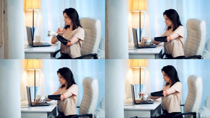 女人正在用控制论的手在笔记本电脑上打字