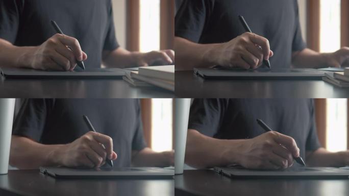 平面设计师illustrator在带有图形平板电脑的笔记本电脑上工作。