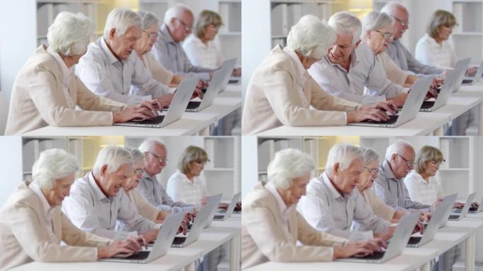 在计算机课上使用笔记本电脑的老年人