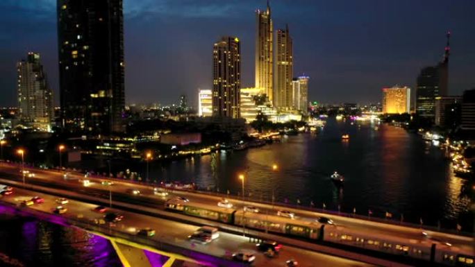 曼谷市对Chao Phraya River，BTS sky train和晚上在Charoen Kru