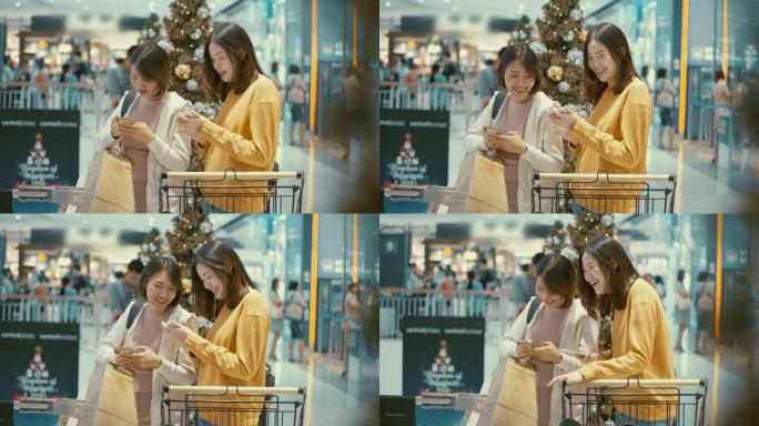 在购物中心使用智能手机的年轻女性