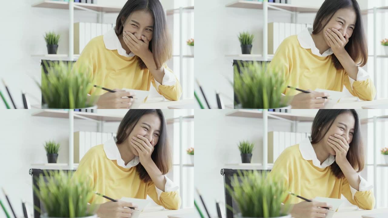 4k分辨率亚洲女人工作时打哈欠和大笑
