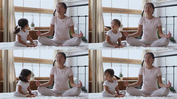 亚洲女童否认与母亲在卧室练习瑜伽。