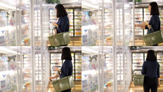 女人喝牛奶在超市购物，慢动作