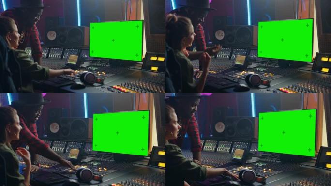制作人和音频工程师在音乐唱片工作室合作制作新专辑，使用绿屏计算机，控制台进行混音和创作热门歌曲。艺术