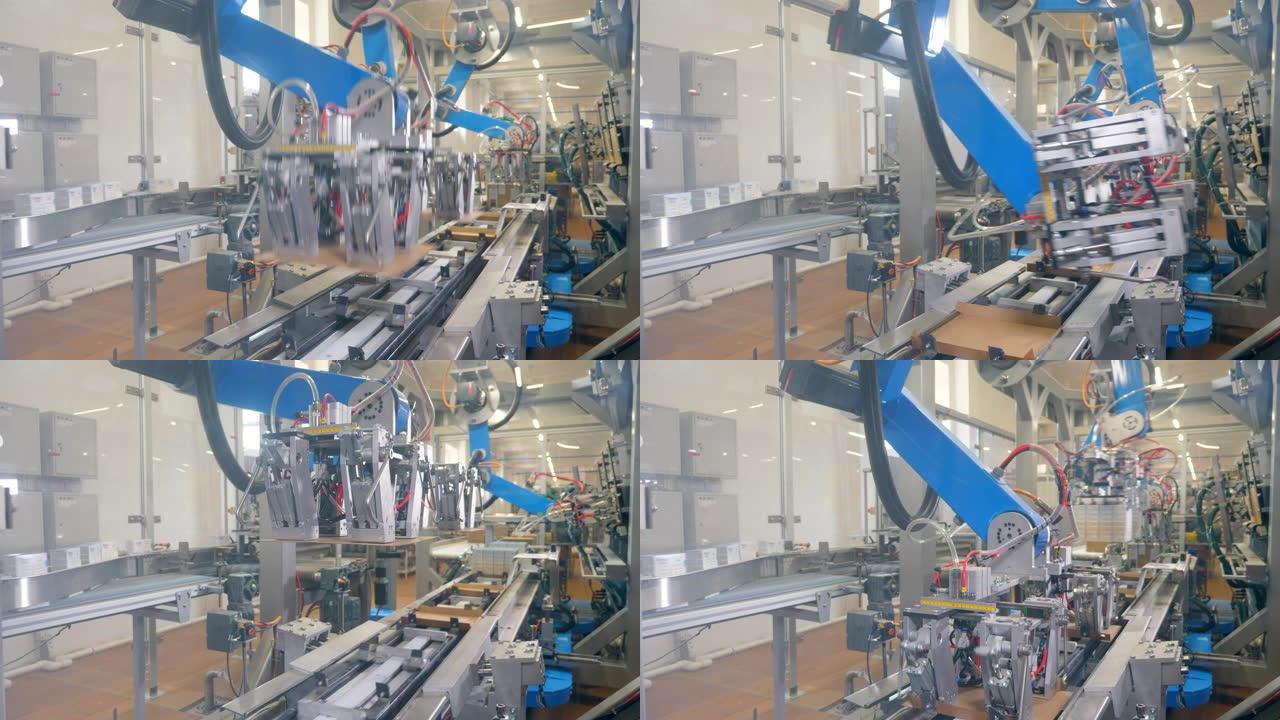 机器人设备将纸板箱装在工厂的移动线上。