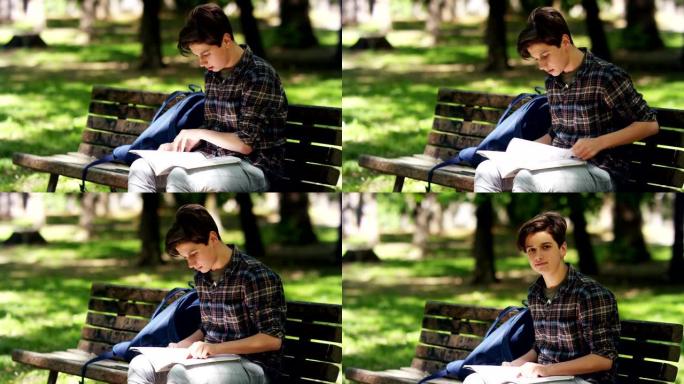 14岁的漂亮少年在公园学习。