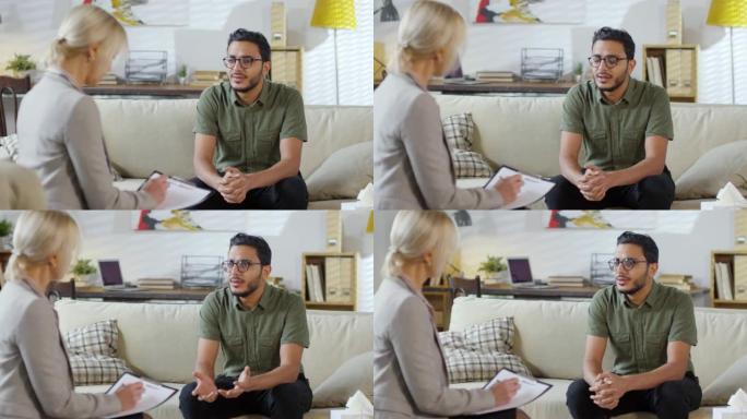 年轻的中东男子与女心理学家交谈