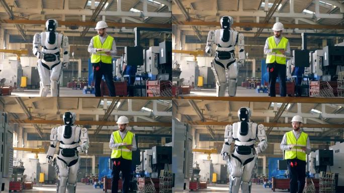 机器人在一名男性专家的控制下沿着工厂行走