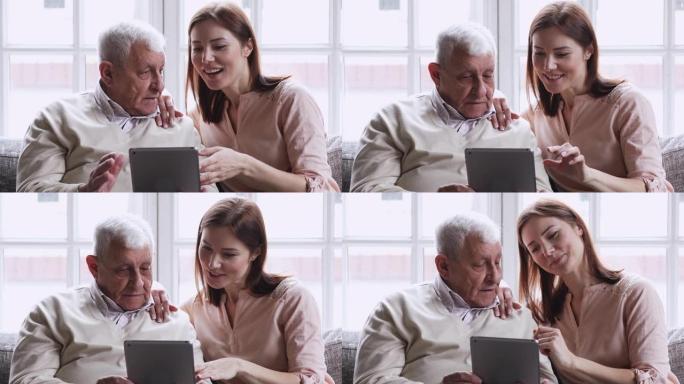 长大的孙女使用数字平板电脑教老爷爷