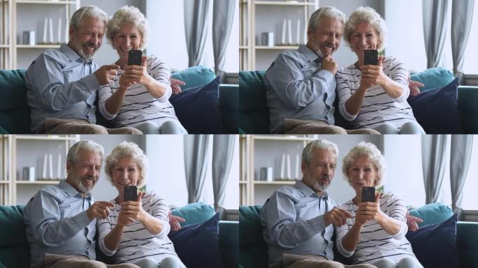 快乐的中年家庭玩得开心，在智能手机上自拍。