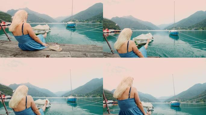 女士无忧无虑的年轻女性游客在意大利加尔达湖的湖中泼水