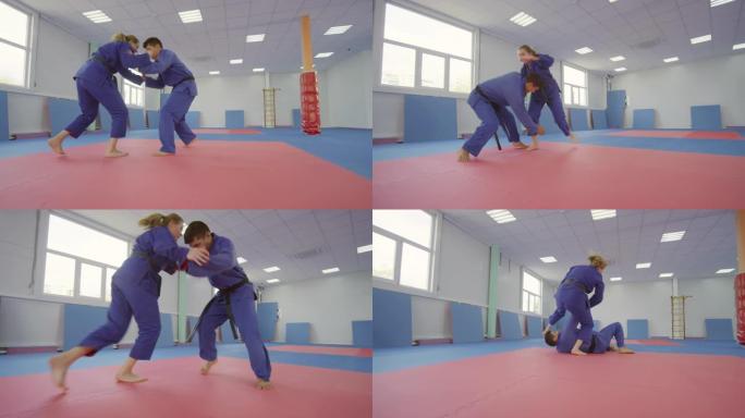 男女格斗运动员在武术馆练习柔术