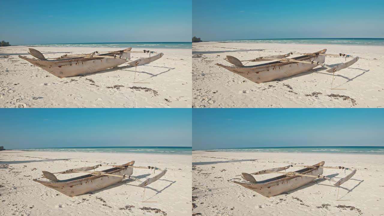 在白色沙滩上的SLO MO传统木制划艇