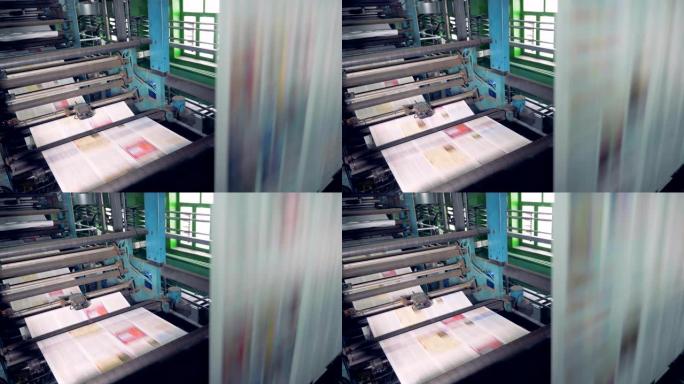 印刷机上的彩纸。报纸印刷设备工作。