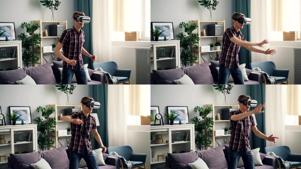 年轻人在虚拟现实眼镜上玩游戏，站在家里戴着设备和移动的手。