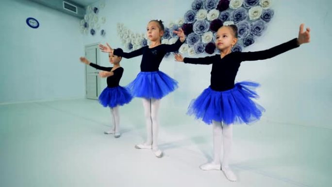 女孩在芭蕾舞课上训练，特写。