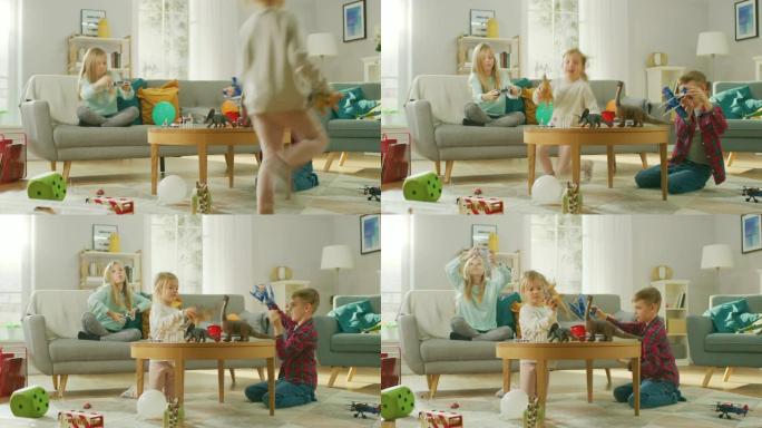 在家: 可爱的女孩在视频游戏机上玩，使用操纵杆控制器，她的年轻兄弟玩玩具飞机，最小的妹妹玩玩具恐龙。