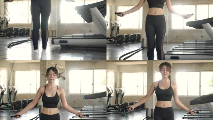 迷人的亚洲女性在健身健康工作室健身房跳绳跳绳。慢动作。医疗保健、运动和运动概念。