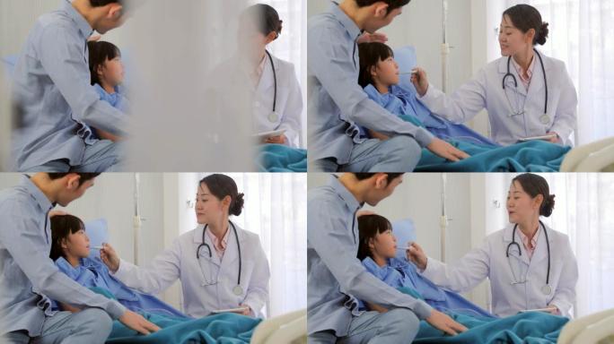 微笑的医生在医院为患者的女婴量体温。医疗保健: 护理