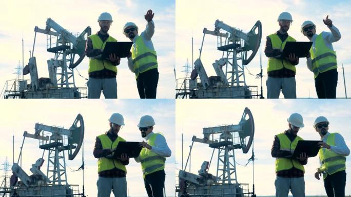 一位能量学专家在采油现场向另一位专家提供指导。石油工业，石油工业，石油部门概念。